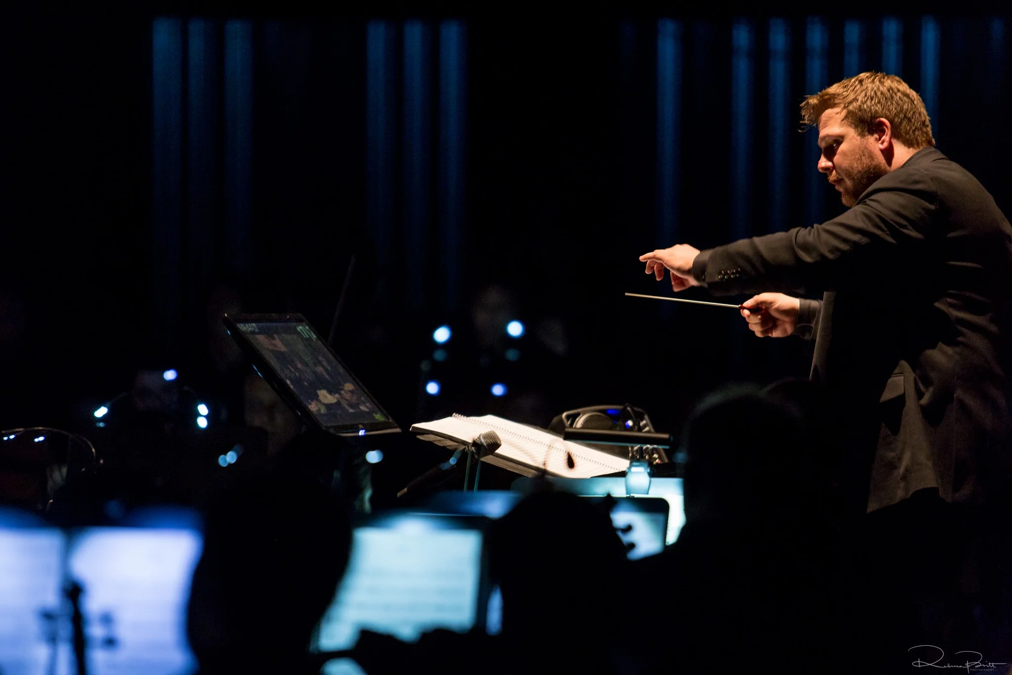 John Jesensky conducting an orchestra on stage